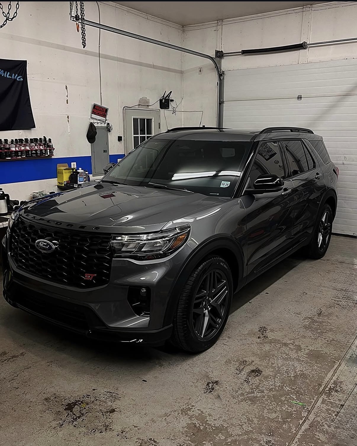 Dark grey Ford Explorer ST with a deep gloss finish inside the Blue Anchor shop